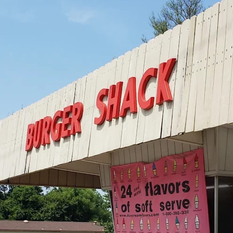 The Burger Shack sign with red letters on a white wooden facade, and a pink soft-serve banner.